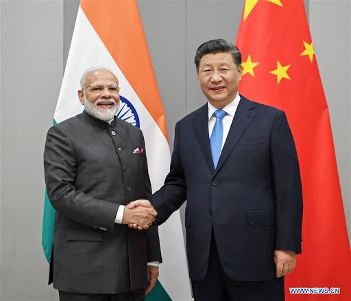 Indian Prime Minister Narendra Modi (left) shakes hands with Chinese President Xi Jinping. Photo credit: Times of Asia