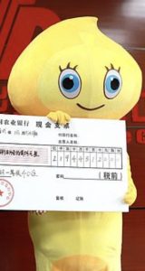 "Mr Li dressed in a yellow cartoon character costume to protect his anonymity as he collected his lottery winnings from Guangxi Welfare Lottery Center